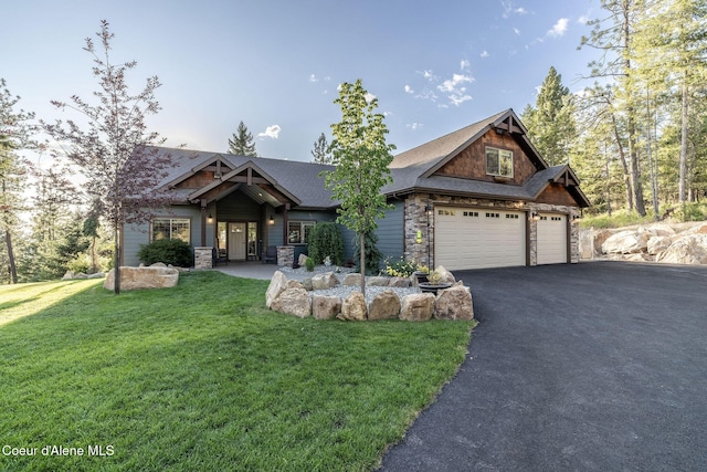 16749 W Cade Rd, Hauser, ID 83854 - craftsman house featuring stone siding, driveway, a front yard, and a garage