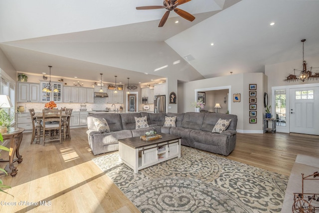 16749 W Cade Rd, Hauser, ID 83854 - living area featuring light wood-style flooring, high vaulted ceiling, ceiling fan, a chandelier, and recessed lighting