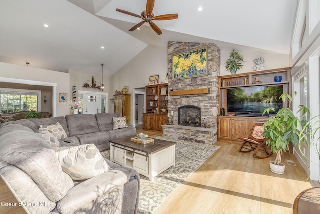 16749 W Cade Rd, Hauser, ID 83854 - living room featuring wood finished floors, a ceiling fan, high vaulted ceiling, a fireplace, and recessed lighting