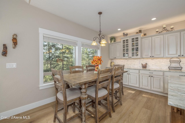 16749 W Cade Rd, Hauser, ID 83854 - dining space featuring light wood finished floors, a chandelier, and recessed lighting