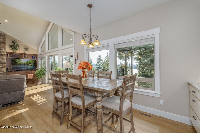 16749 W Cade Rd, Hauser, ID 83854 - dining space with healthy amount of natural light, light wood-style floors, a chandelier, and lofted ceiling