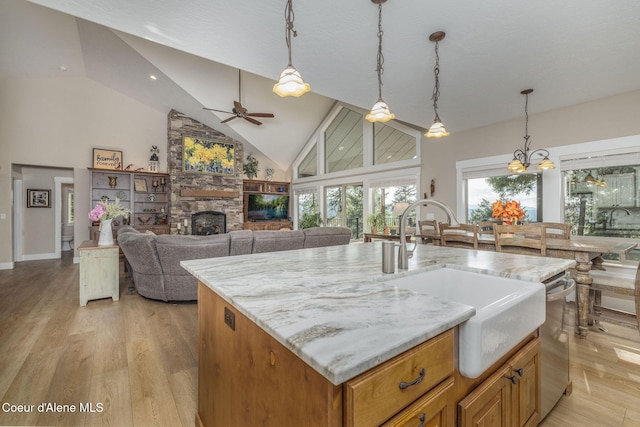16749 W Cade Rd, Hauser, ID 83854 - kitchen featuring a ceiling fan, high vaulted ceiling, a stone fireplace, light wood finished floors, and dishwasher