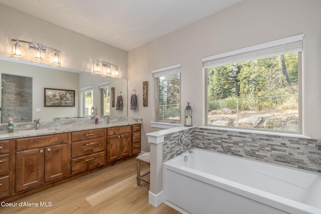 16749 W Cade Rd, Hauser, ID 83854 - full bath featuring double vanity, a bath, and wood finished floors