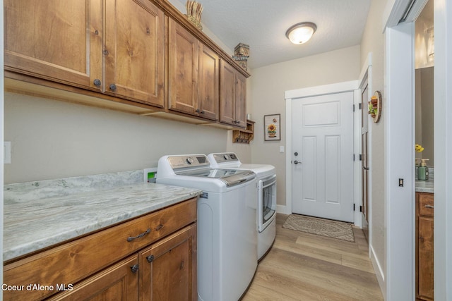 16749 W Cade Rd, Hauser, ID 83854 - laundry room featuring cabinet space, independent washer and dryer, and light wood-style floors