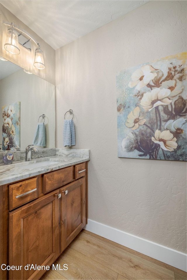 16749 W Cade Rd, Hauser, ID 83854 - bathroom featuring wood finished floors and vanity