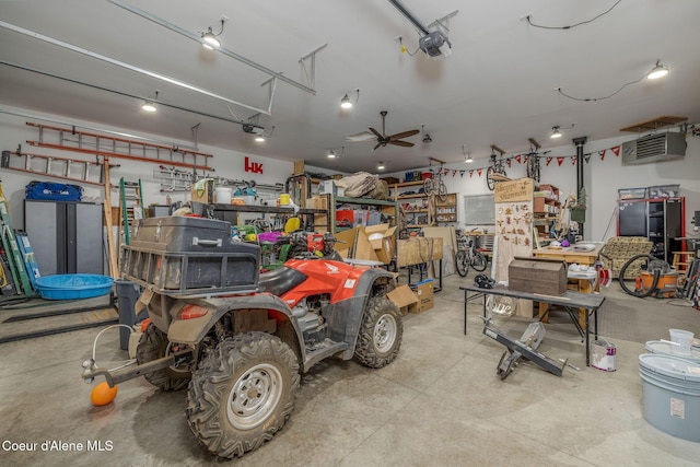 16749 W Cade Rd, Hauser, ID 83854 - garage with a garage door opener, a ceiling fan, and a heating unit