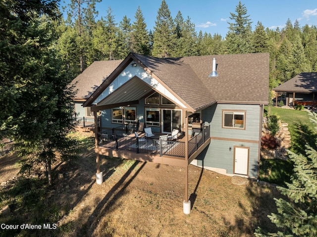 16749 W Cade Rd, Hauser, ID 83854 - rear view of house featuring a shingled roof and a lawn