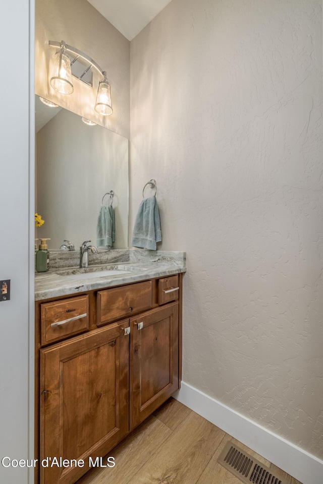 16749 W Cade Rd, Hauser, ID 83854 - bathroom featuring wood finished floors and vanity