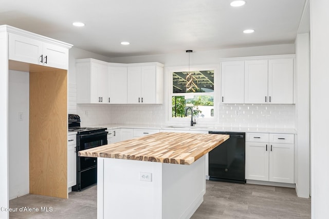 170 10th St, Priest River, ID 83856 - kitchen with black appliances, butcher block countertops, white cabinetry, recessed lighting, and a kitchen island