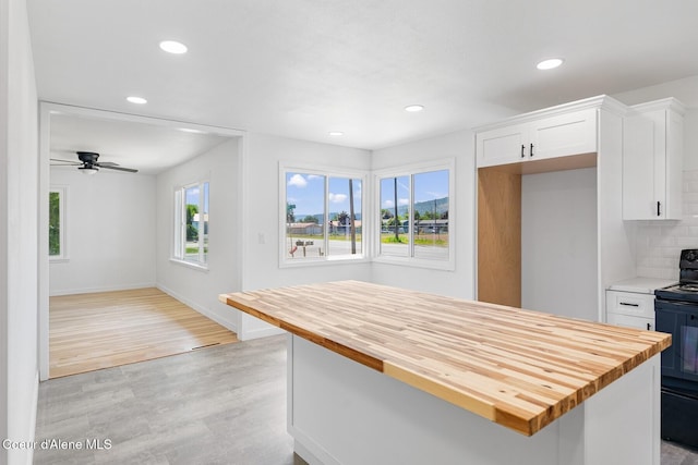 170 10th St, Priest River, ID 83856 - kitchen featuring wooden counters, black range with electric cooktop, white cabinetry, recessed lighting, and light wood-style floors