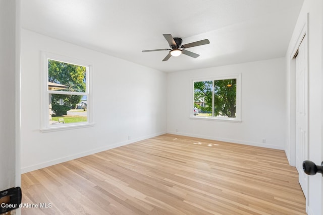 170 10th St, Priest River, ID 83856 - unfurnished bedroom featuring multiple windows, light wood-style floors, a closet, and a ceiling fan