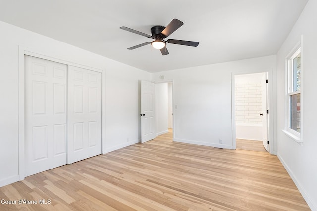170 10th St, Priest River, ID 83856 - unfurnished bedroom featuring light wood-style floors, a closet, ensuite bath, and a ceiling fan
