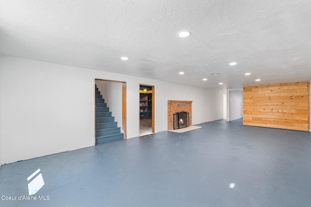 170 10th St, Priest River, ID 83856 - finished below grade area featuring recessed lighting, stairway, a textured ceiling, and a fireplace