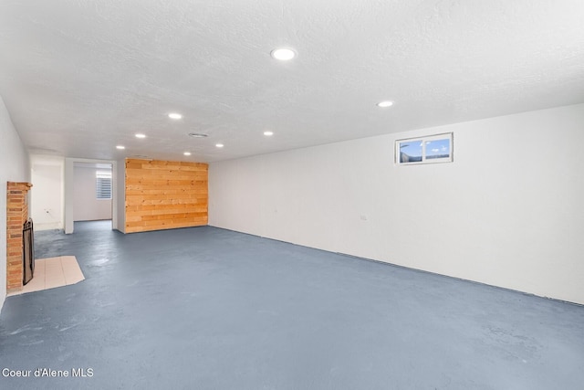 170 10th St, Priest River, ID 83856 - finished basement featuring a fireplace with flush hearth, recessed lighting, and a textured ceiling