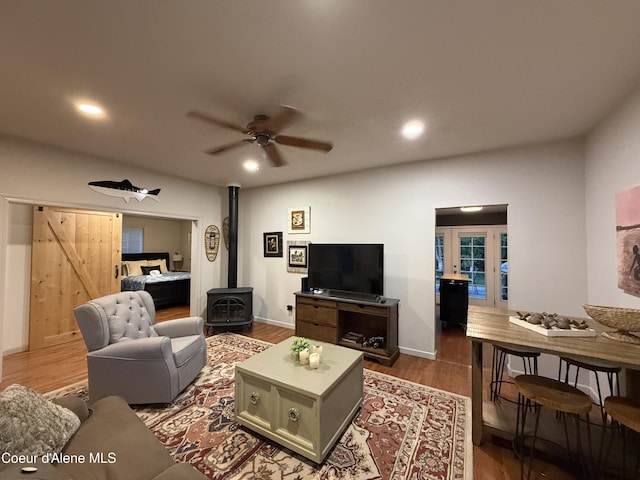 912 N 5th St, Coeur Dalene, ID 83814 - living area featuring a wood stove, ceiling fan, wood finished floors, and recessed lighting