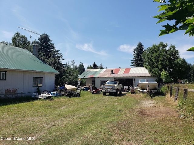 701 N Pine St, Clark Fork, ID 83811 - view of green lawn featuring a pole building and an outbuilding