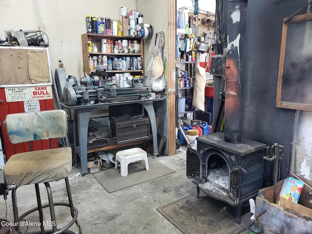 701 N Pine St, Clark Fork, ID 83811 - miscellaneous room featuring concrete floors and a wood stove