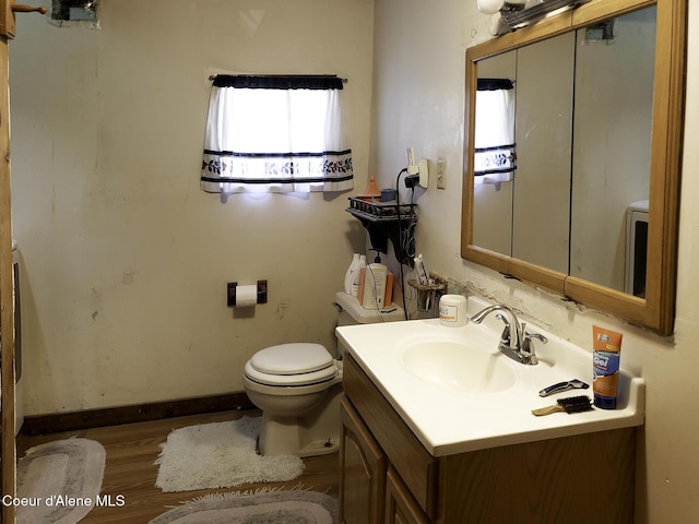 701 N Pine St, Clark Fork, ID 83811 - half bathroom with vanity and wood finished floors
