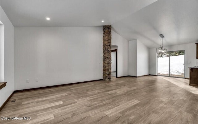 116 Prospector Lp, Kellogg, ID 83837 - unfurnished living room featuring light wood-style flooring, a chandelier, and lofted ceiling