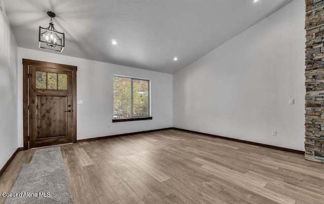 116 Prospector Lp, Kellogg, ID 83837 - foyer entrance featuring lofted ceiling, plenty of natural light, a chandelier, and wood finished floors