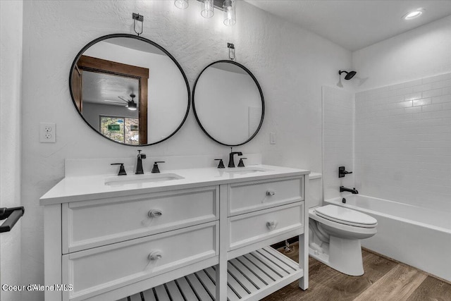 116 Prospector Lp, Kellogg, ID 83837 - bathroom with wood finished floors, double vanity,  shower combination, a textured wall, and ceiling fan