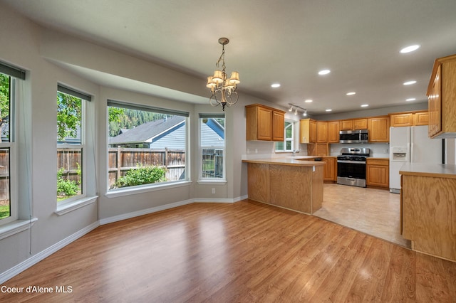 3749 N Miners Loop, Coeur Dalene, ID 83815 - kitchen with appliances with stainless steel finishes, a chandelier, light countertops, light wood-style flooring, and recessed lighting