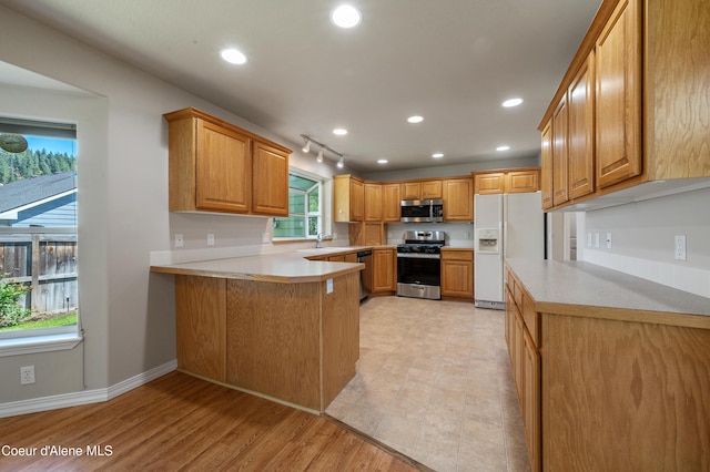 3749 N Miners Loop, Coeur Dalene, ID 83815 - kitchen featuring stainless steel appliances, a peninsula, light countertops, recessed lighting, and brown cabinets