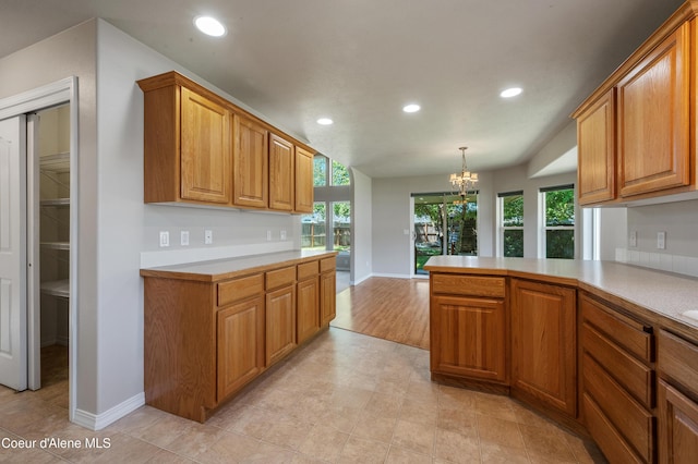 3749 N Miners Loop, Coeur Dalene, ID 83815 - kitchen with recessed lighting, a chandelier, light countertops, plenty of natural light, and brown cabinetry
