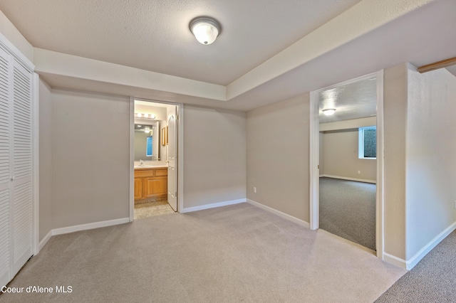 3749 N Miners Loop, Coeur Dalene, ID 83815 - unfurnished bedroom with light colored carpet, a closet, and connected bathroom