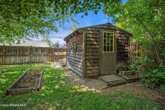 3749 N Miners Loop, Coeur Dalene, ID 83815 - view of shed with a vegetable garden and a fenced backyard