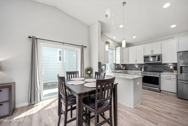 7991 N Girard Cir, Coeur Dalene, ID 83815 - dining room with vaulted ceiling, light wood finished floors, and recessed lighting