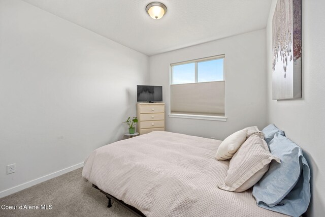 7991 N Girard Cir, Coeur Dalene, ID 83815 - carpeted bedroom with baseboards and lofted ceiling