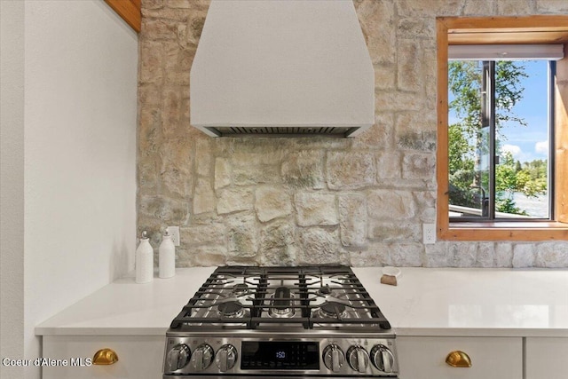 400 S Ohana Beach Dr, Coeur Dalene, ID 83814 - kitchen with ventilation hood, gas stove, light countertops, and white cabinets