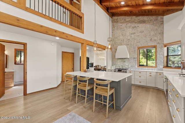 400 S Ohana Beach Dr, Coeur Dalene, ID 83814 - kitchen with a wood ceiling with exposed beams, light countertops, a towering ceiling, range, and white cabinetry