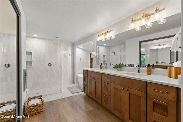 400 S Ohana Beach Dr, Coeur Dalene, ID 83814 - full bath with a soaking tub, double vanity, a stall shower, and wood finished floors