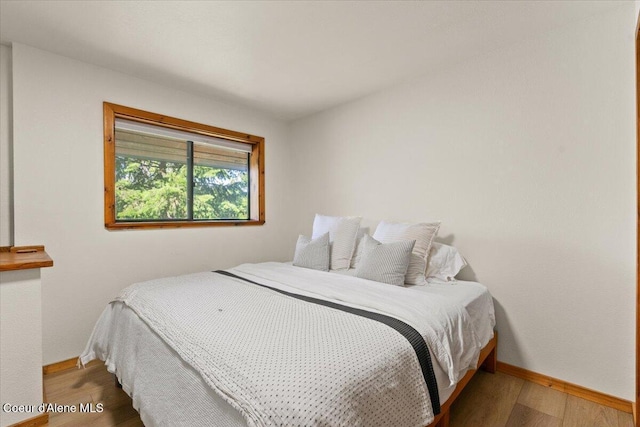 400 S Ohana Beach Dr, Coeur Dalene, ID 83814 - bedroom featuring baseboards and wood finished floors