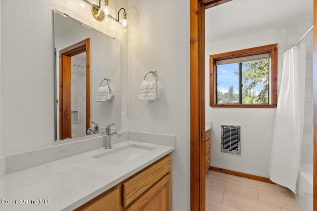 400 S Ohana Beach Dr, Coeur Dalene, ID 83814 - bathroom featuring heating unit, vanity, and shower / bath combo