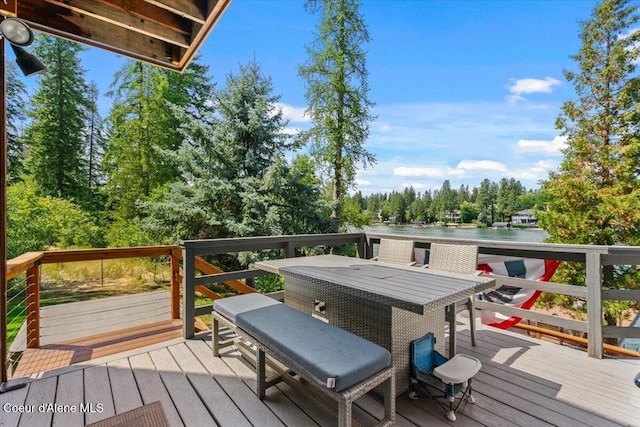 400 S Ohana Beach Dr, Coeur Dalene, ID 83814 - wooden terrace featuring outdoor dining space, a water view, and view of scattered trees