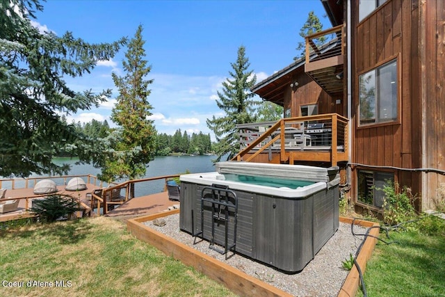 400 S Ohana Beach Dr, Coeur Dalene, ID 83814 - view of grassy yard featuring a hot tub and a deck with water view