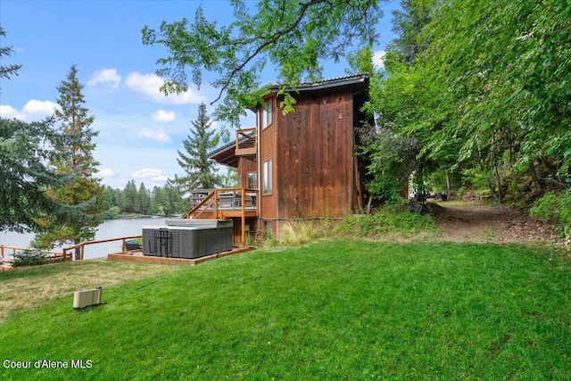 400 S Ohana Beach Dr, Coeur Dalene, ID 83814 - view of grassy yard featuring a hot tub and a deck with water view