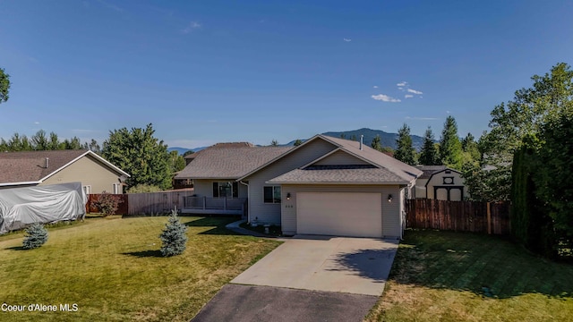 208 Brittany Loop, Sandpoint, ID 83864 - single story home featuring driveway, a garage, a mountain view, and roof with shingles