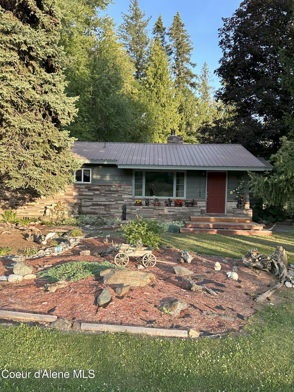 203 3rd St, Dover, ID 83825 - ranch-style home with a metal roof, a chimney, and stone siding