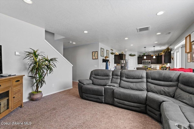 838 W Jenicek Loop, Post Falls, ID 83854 - living room with light colored carpet, recessed lighting, stairs, and a textured ceiling