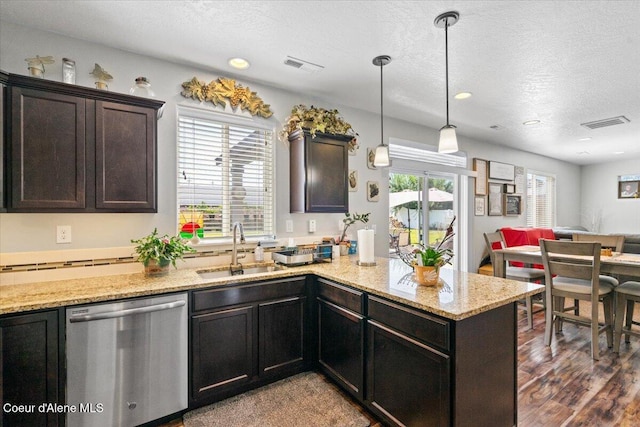 838 W Jenicek Loop, Post Falls, ID 83854 - kitchen with dishwasher, open floor plan, a peninsula, light stone countertops, and a textured ceiling