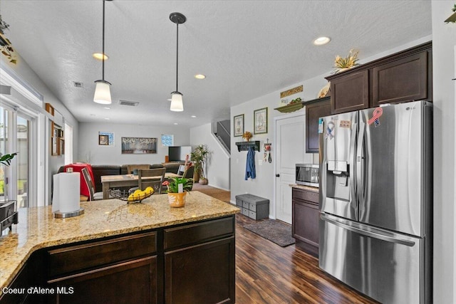 838 W Jenicek Loop, Post Falls, ID 83854 - kitchen with stainless steel appliances, dark brown cabinets, open floor plan, dark wood-type flooring, and hanging light fixtures