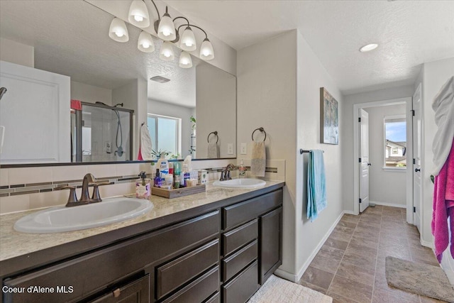 838 W Jenicek Loop, Post Falls, ID 83854 - full bathroom with a textured ceiling, double vanity, a shower stall, and healthy amount of natural light