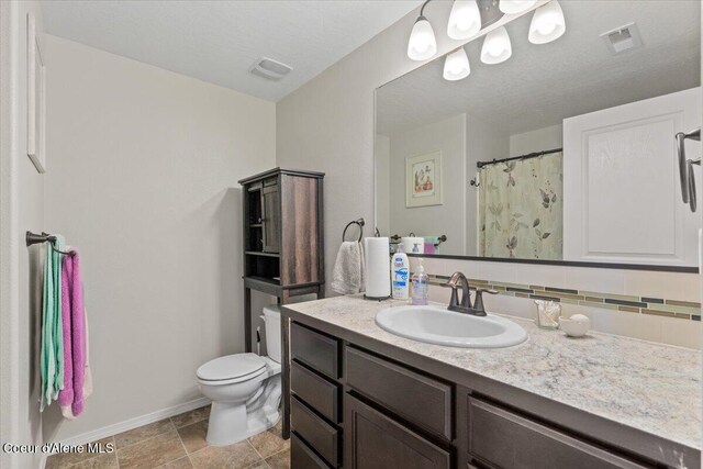838 W Jenicek Loop, Post Falls, ID 83854 - bathroom with vanity and decorative backsplash