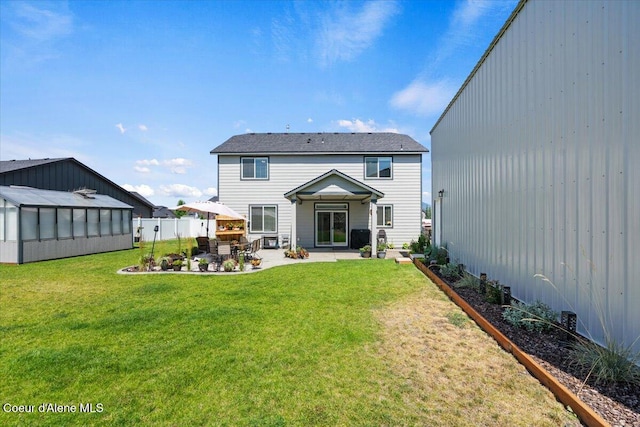 838 W Jenicek Loop, Post Falls, ID 83854 - rear view of property with a greenhouse, a patio area, and an outbuilding