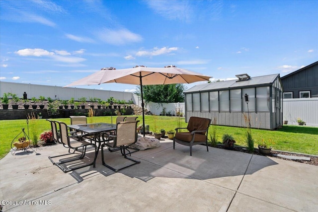838 W Jenicek Loop, Post Falls, ID 83854 - fenced backyard featuring a patio area, outdoor dining area, an outbuilding, and a greenhouse
