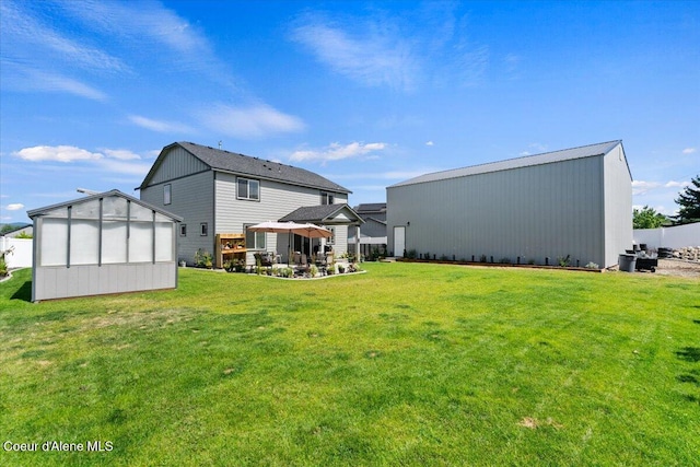 838 W Jenicek Loop, Post Falls, ID 83854 - rear view of house with an outbuilding and a yard